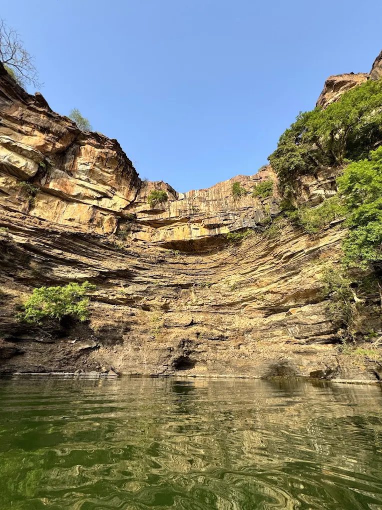 Towering layered cliffs rising from the Chambal River gorge